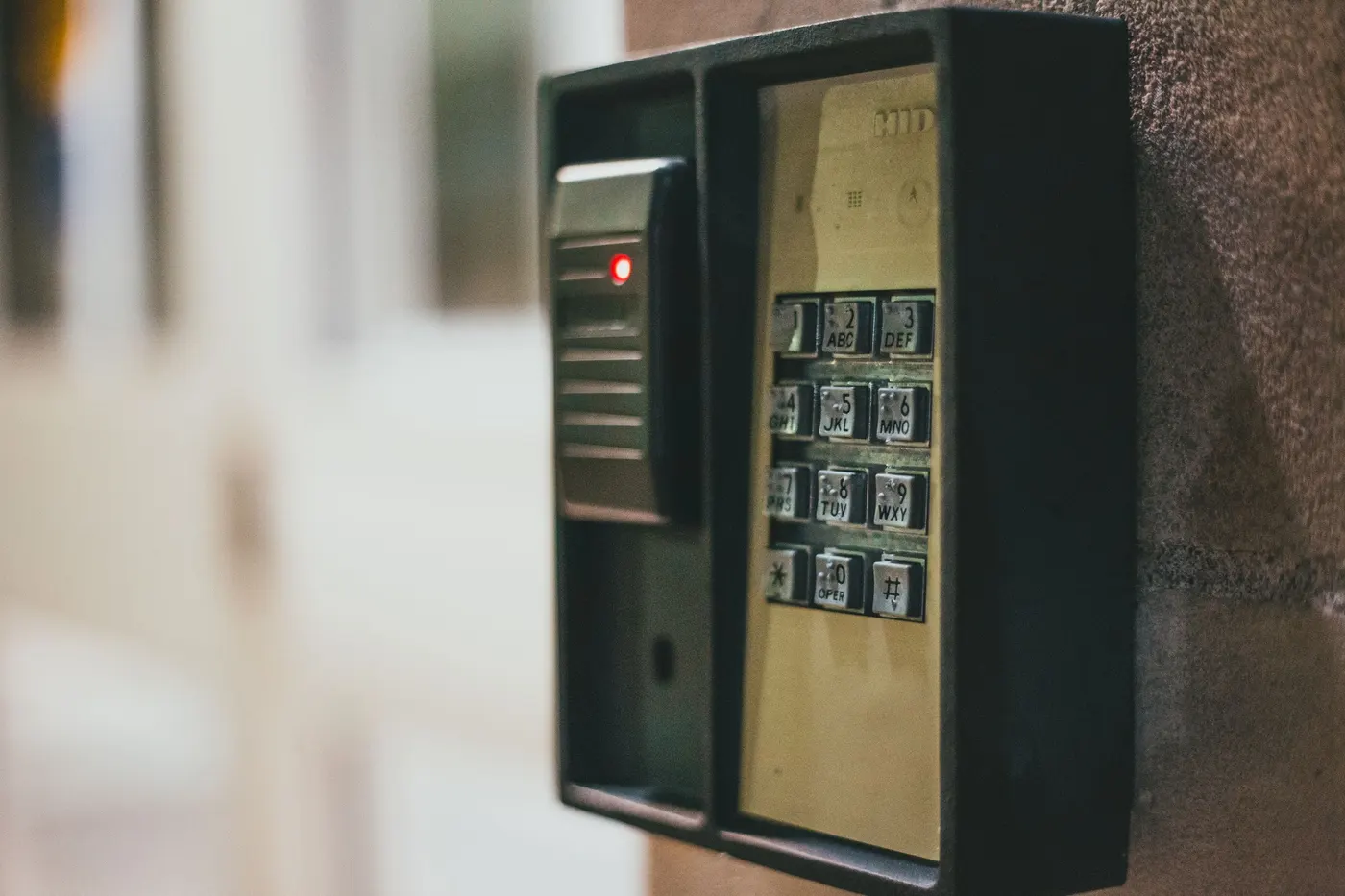 Door access keypad and reader mounted on a wall