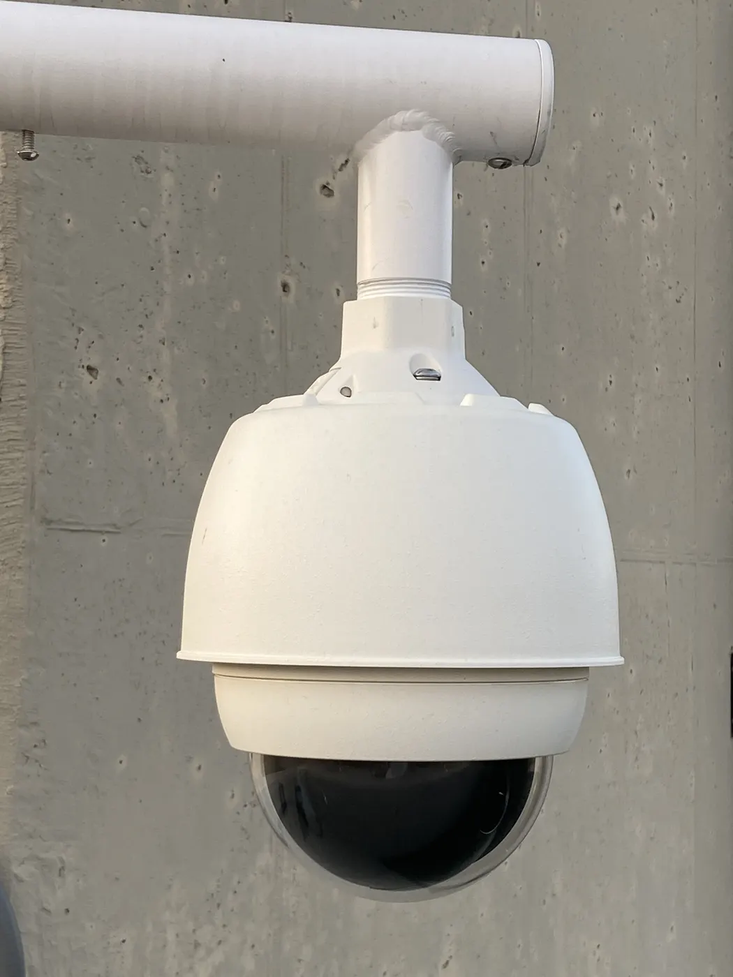 PTZ dome security camera mounted on a wall bracket