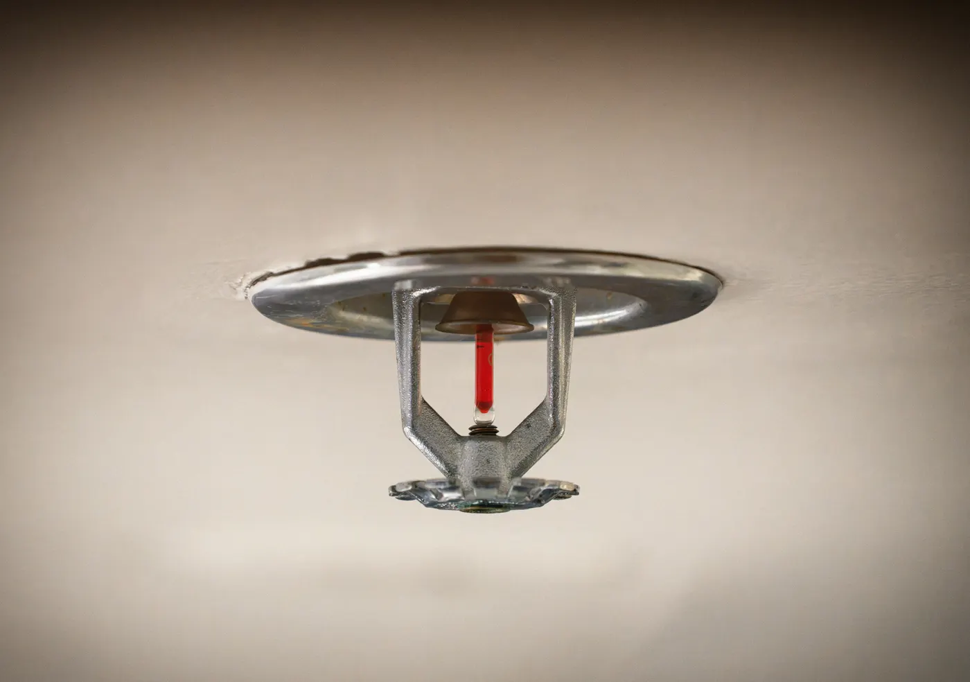 Ceiling fire sprinkler head with red glass bulb