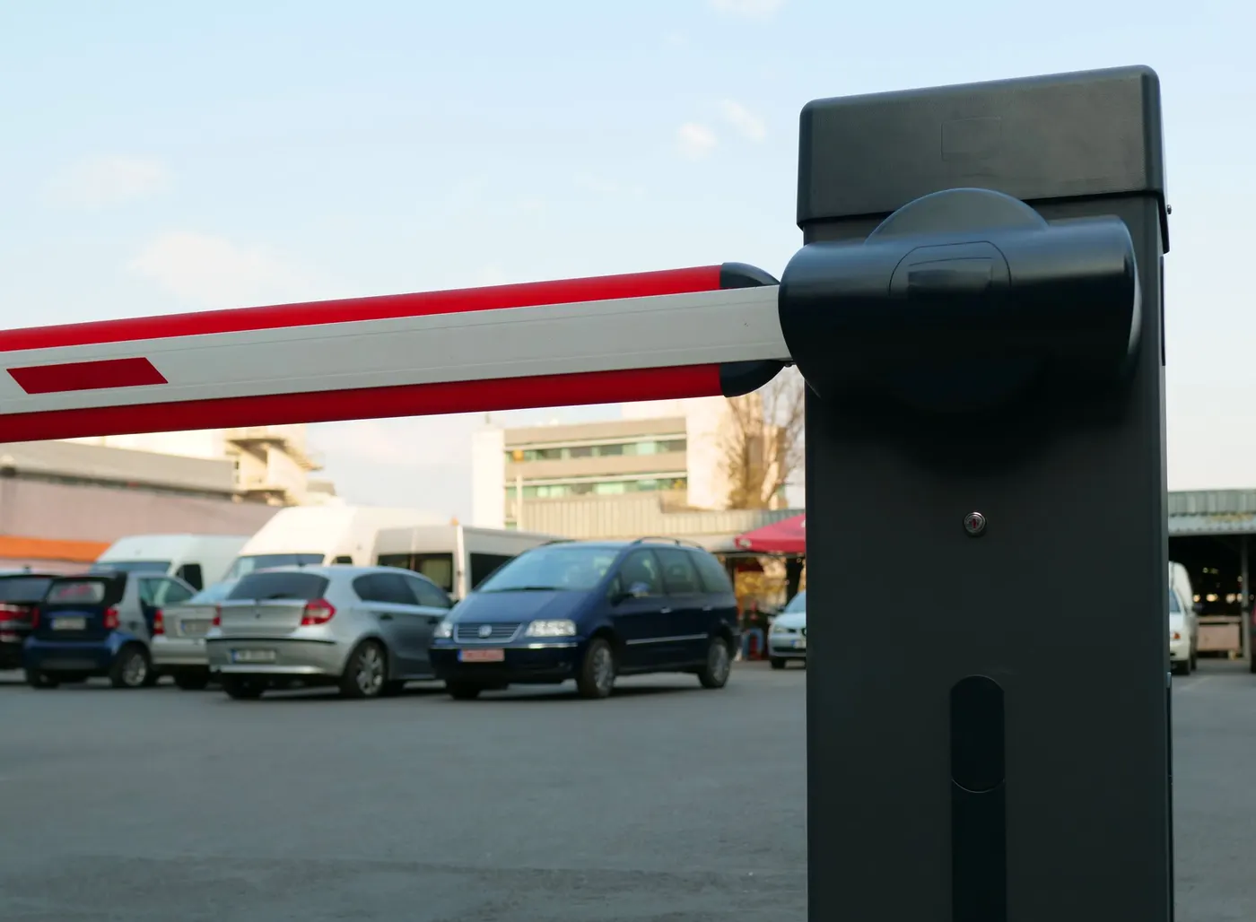 Close-up of a parking boom barrier arm and motor housing