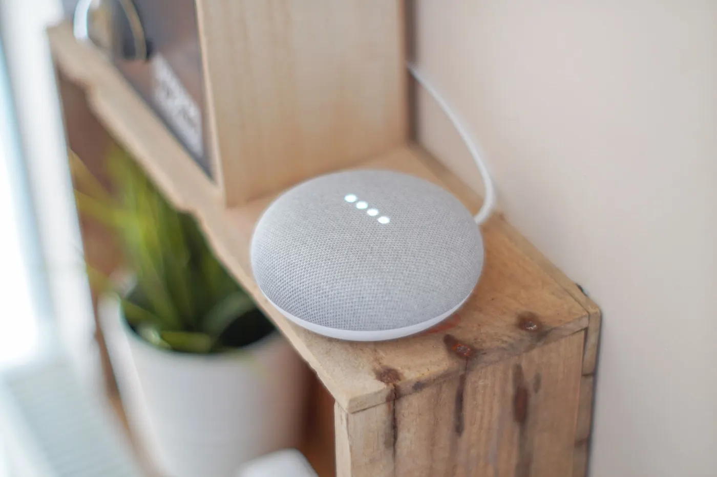 Smart speaker voice assistant on a wooden shelf
