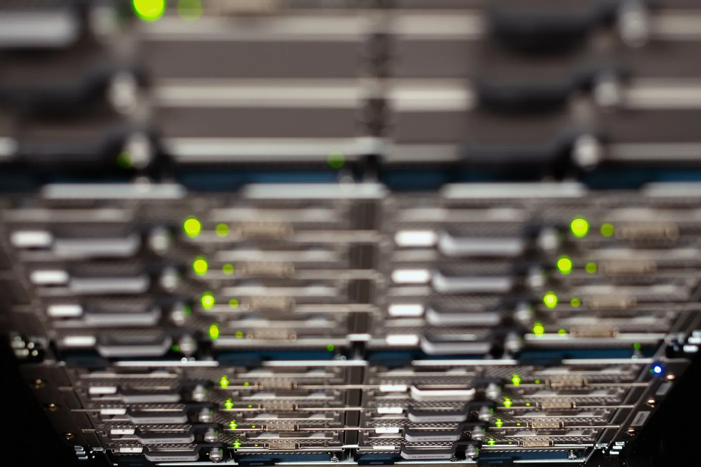 Overhead cable trays above rows of server racks in a data centre