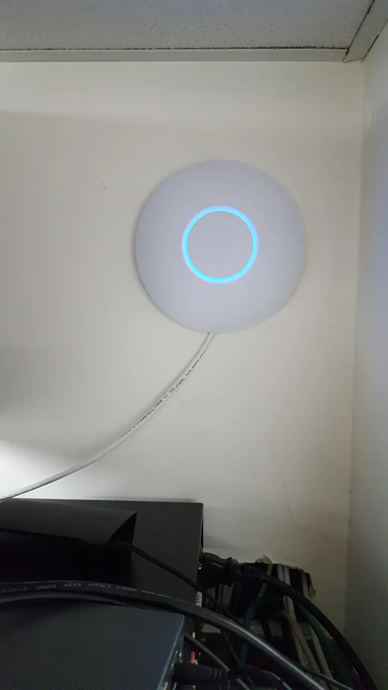 Ceiling-mounted Ubiquiti UniFi Wi-Fi access point