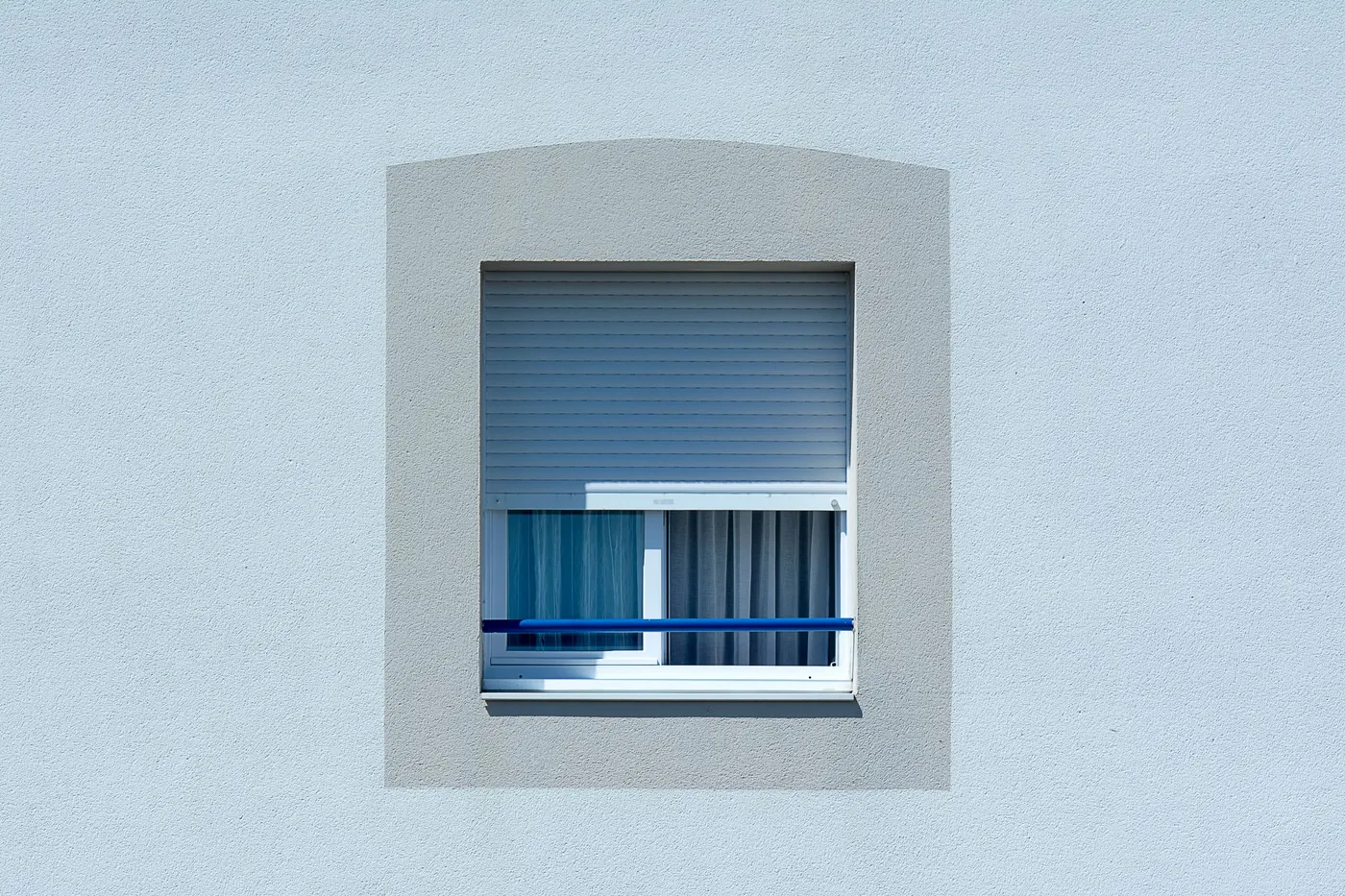 Window with a roller shutter partly lowered